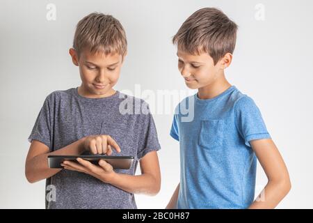 Children using digital tablet pc computer. Technology, online learning, education, distance learning, game apps for kids Stock Photo