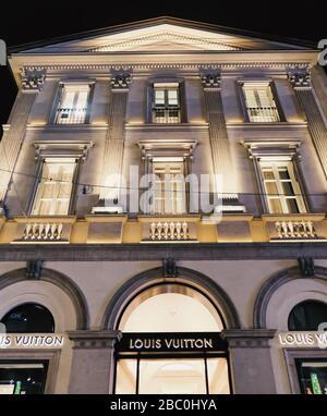 Milan, Italy circa January, 2020: Historical buildings, stores and boutique shops on Via Montenapoleone street in Milan at night, luxury shopping street Stock Photo