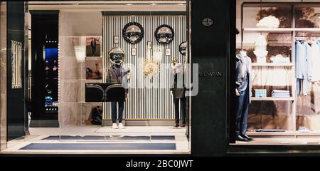 Milan, Italy circa January, 2020: Historical buildings, stores and boutique shops on Via Montenapoleone street in Milan at night, luxury shopping street Stock Photo