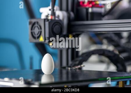 white plastic model of egg printed on a 3D printer. modern technology. Stock Photo