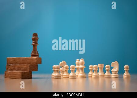 Brown king chess standing on a wooden stand. The concept of Leaders in good organizations must have a vision and can predict business trends and asses Stock Photo