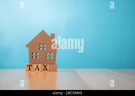 Wooden house on tax. The concept of finance and investment in property residential and tax payment. Stock Photo