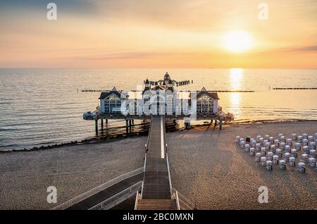Classic panoramic view of idyllic scenery at famous Sellin Seebruecke (Sellin Pier) in beautiful golden morning light at sunrise in summer, Ostseebad Stock Photo