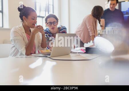 Female architects working at laptop in conference room meeting Stock Photo