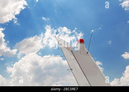 Plane tail against blue sky. Tail section of small aircraft Stock Photo