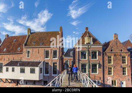 Young women taking a bicycle tour in historic city Appingedam, Netherlands Stock Photo