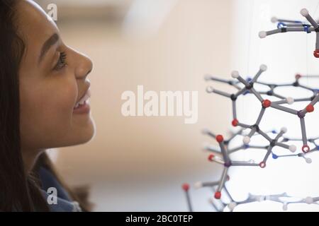 Curious girl student examining molecular structure Stock Photo