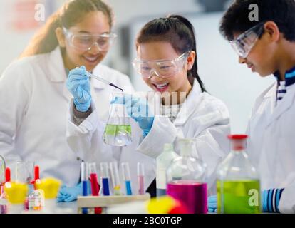 Students conducting scientific experiment in laboratory classroom Stock Photo