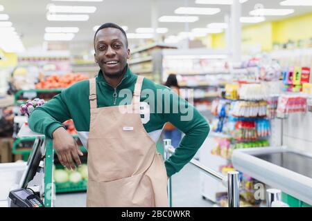 Portrait confident male grocer working in supermarket Stock Photo