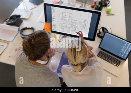 Architects meeting, viewing digital blueprints on computer Stock Photo