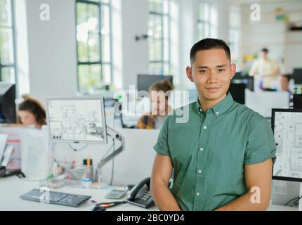 Portrait confident male architect in open plan office Stock Photo