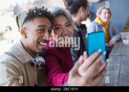 Smiling young couple taking selfie in camera phone Stock Photo