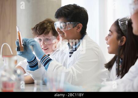 Students conducting scientific experiment in laboratory classroom Stock Photo