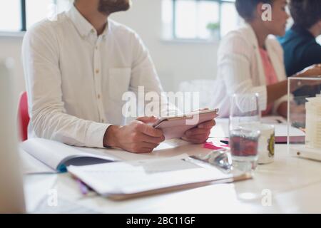 Male architect using digital tablet in conference room meeting Stock Photo