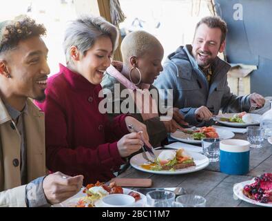 Friends eating breakfast at restaurant outdoor patio Stock Photo