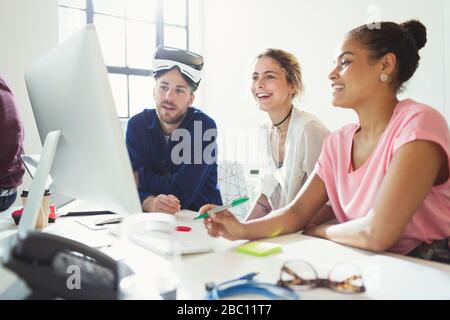Computer programmers programming virtual reality simulator glasses at computer in office Stock Photo