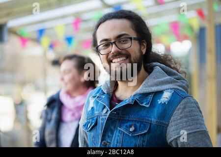 Portrait smiling young man with beard and long hair Stock Photo