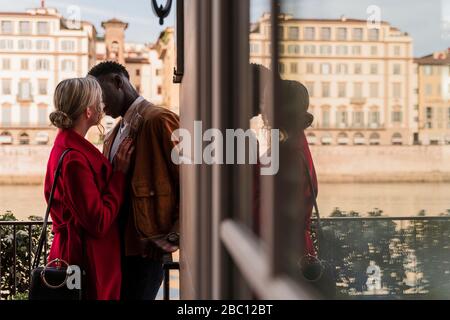 Affectionate young couple kissing in the city of Florence, Italy Stock Photo