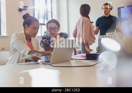 Female architects using laptop in conference room meeting Stock Photo