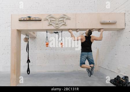 Man doing pull-ups before climbing Stock Photo