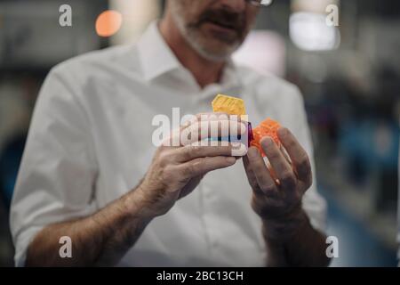 Man examining workpiece in a factory Stock Photo