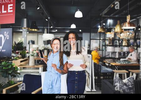 Portrait happy women shopping in home decor shop Stock Photo