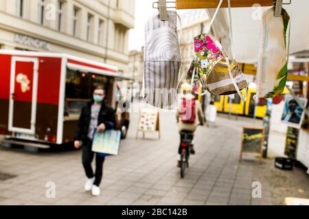 Berlin, Germany. 02nd Apr, 2020. Mouth and nose masks are hanging from a sales stand at Hackescher Markt. More and more people are sewing their own mouth and nose protectors. Credit: Carsten Koall/dpa/Alamy Live News