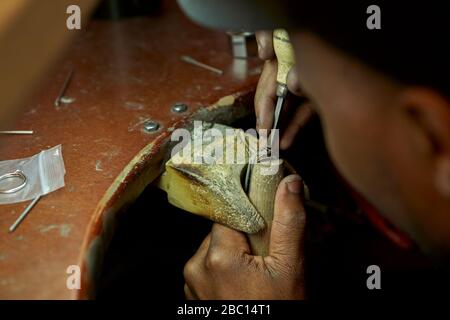 Man repairing a ring with a missing diamond Stock Photo