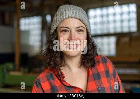 Portrait of confident craftswoman in her workshop Stock Photo