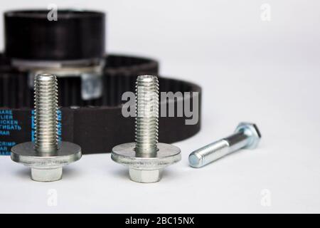 Repair kit: gear belt and bolts isolated on a white background. Stock Photo