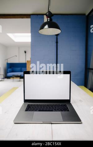 Laptop on table in loft office Stock Photo
