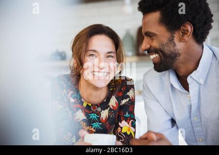 Portrait smiling, happy multi-ethnic couple drinking coffee Stock Photo