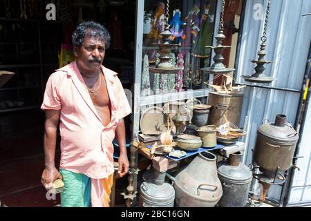 Vendor standing outside his antique store on Rampart Street in Galle, Sri Lanka Stock Photo