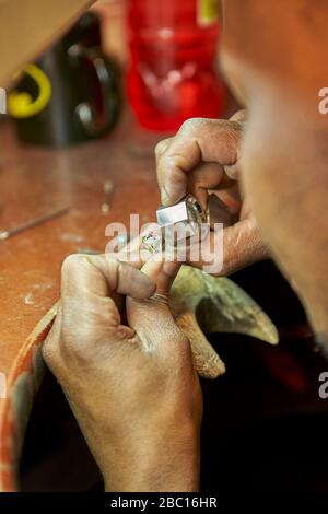 Man repairing a ring with a missing diamond Stock Photo