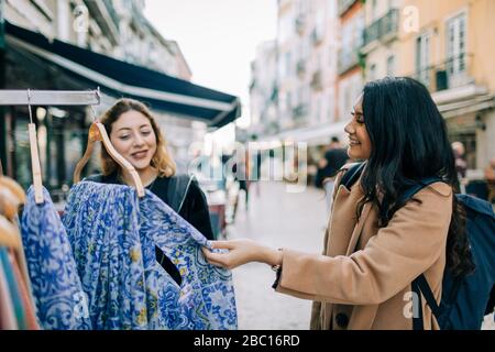 Two young women shopping together in the city, Lisbon, Portugal Stock Photo