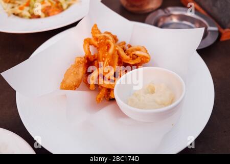 Fried squid with tartar sauce on white dish Stock Photo