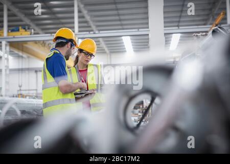 Workers talking in factory Stock Photo