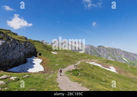 Switzerland, St Gallen Canton, Glarus Alps, Man hiking the Panoramic hiking trail in the Tectonic Arena Sardona Stock Photo