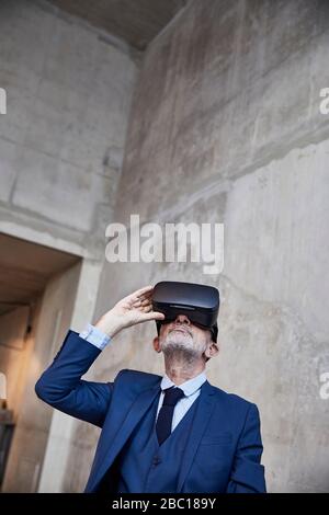 Senior businessman using VR glasses Stock Photo