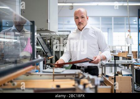 Businessman in a printing plant checking product Stock Photo