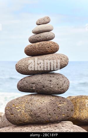 Balanced stone stack on a beach, selective focus. Stock Photo