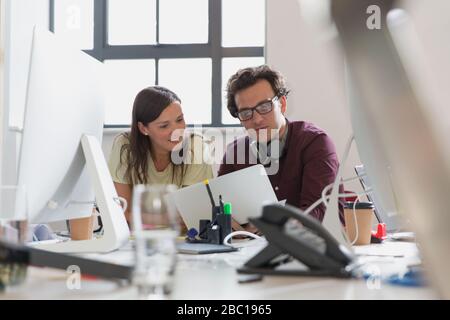 Designers using laptop in office Stock Photo