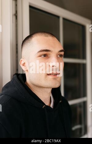 Portrait of pensive young man with shaved head Stock Photo