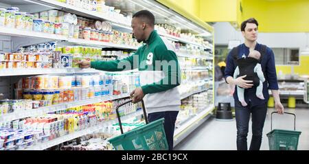 Men shopping in supermarket Stock Photo