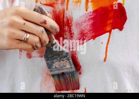 Hand of a female painter painting a picture Stock Photo