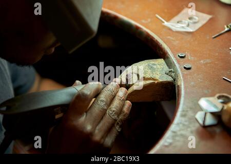 Man repairing a ring with a missing diamond Stock Photo