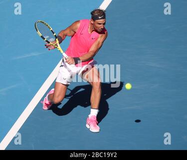 Spanish tennis player Rafael Nadal (ESP) playing backhand return shot in Australian Open 2020 Tennis Tournament, Melbourne Park, Melbourne, Victoria, Stock Photo