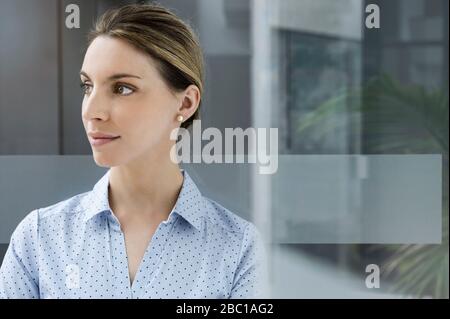 Portrait of a confident young businesswoman in office looking away Stock Photo