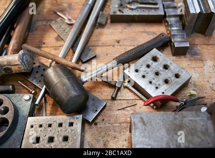 Goldsmith, different kind of tools on workbench Stock Photo