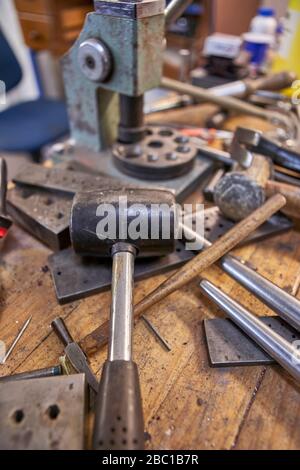 Goldsmith, different kind of tools on workbench Stock Photo